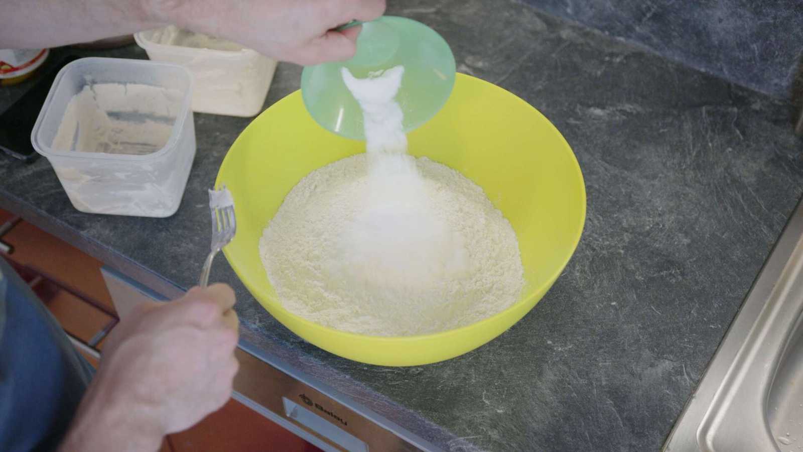 Salt getting added into a large bowl