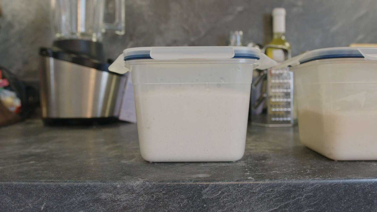 Covered dough in container rising