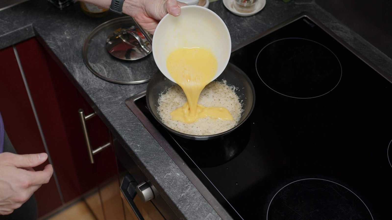 Eggs being added on top of the cheese