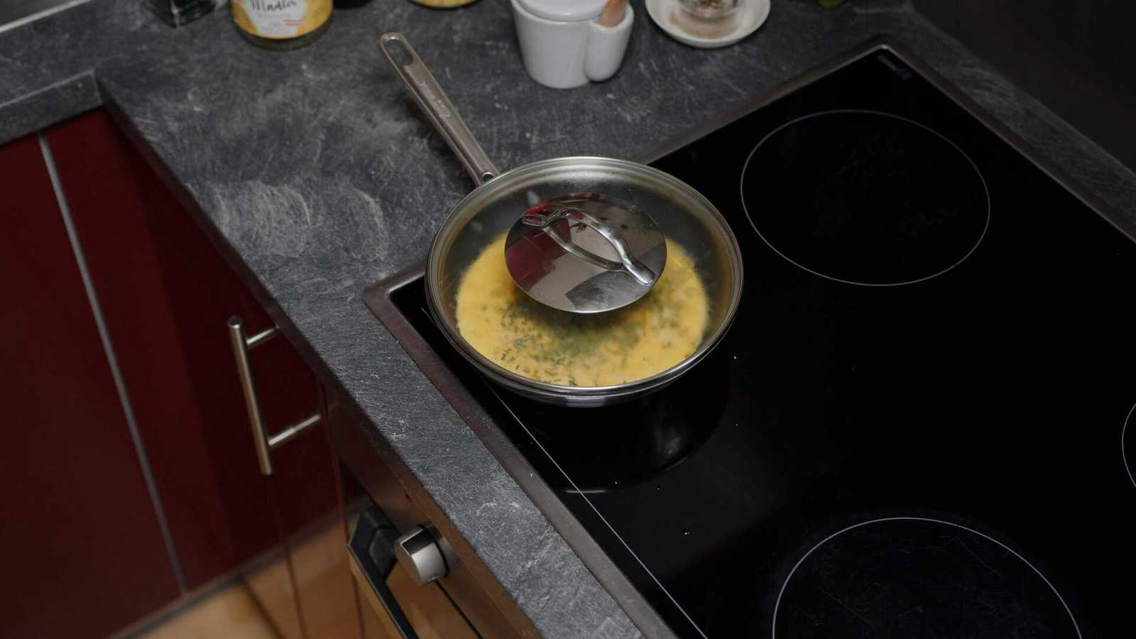 Omelette in the pan with covered with a lid