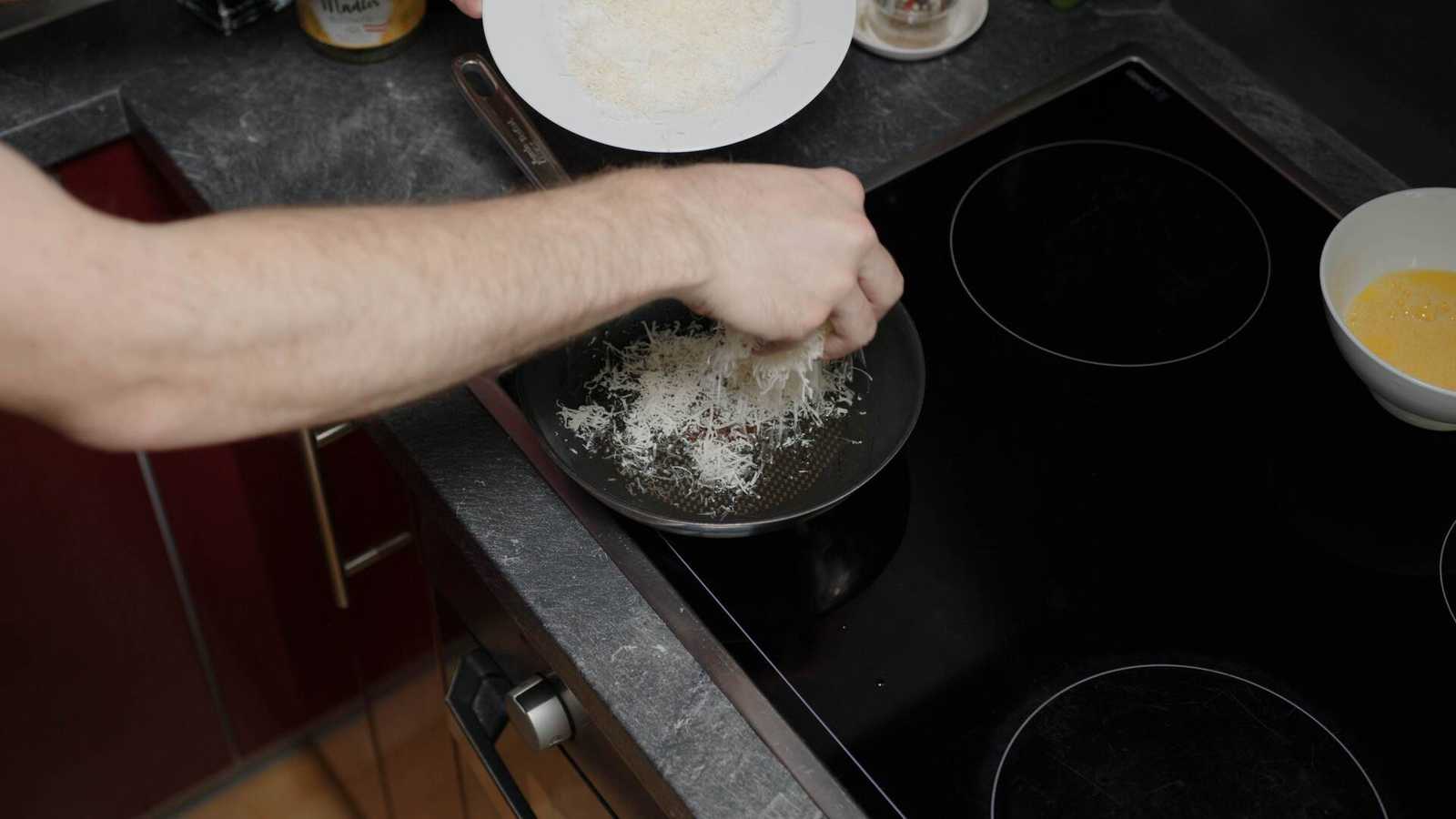 Parmesan being added into the pan