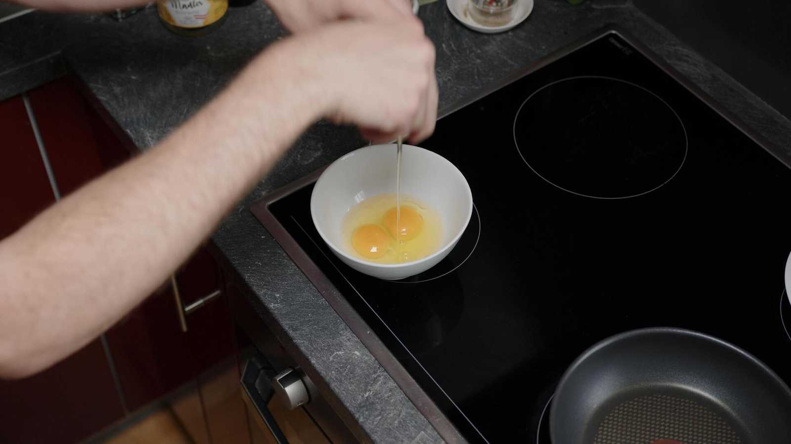 Eggs being cracked into a bowl