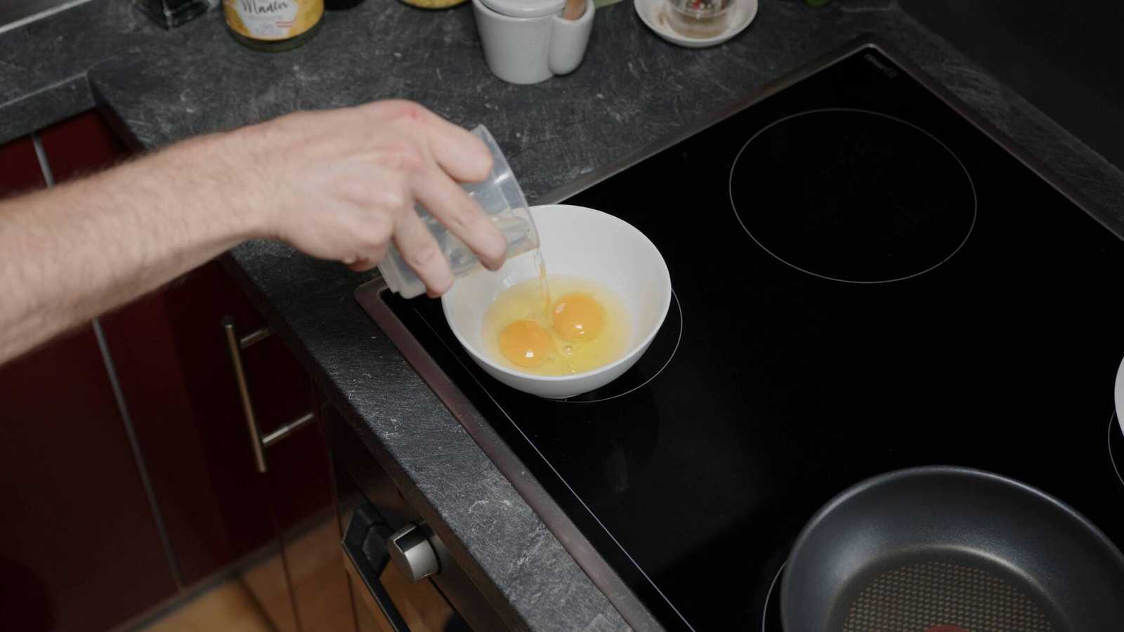 Splash of water being added to the eggs