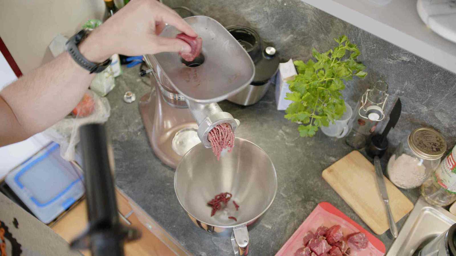 Meat grinder that is grinding beef