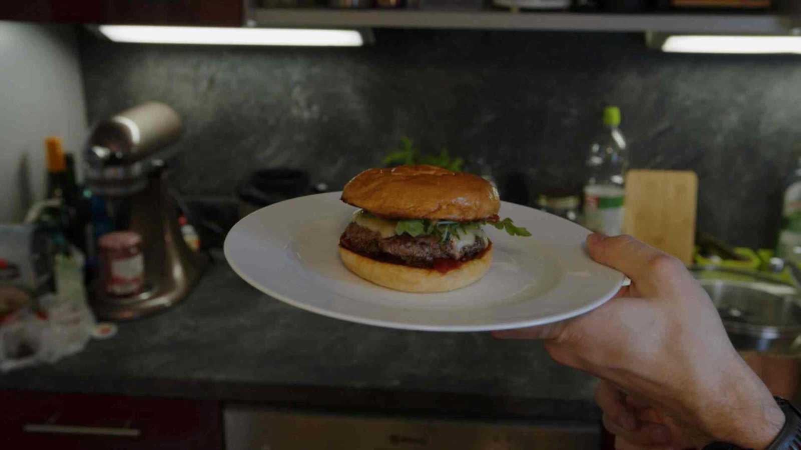 Finished burger being shown on a plate