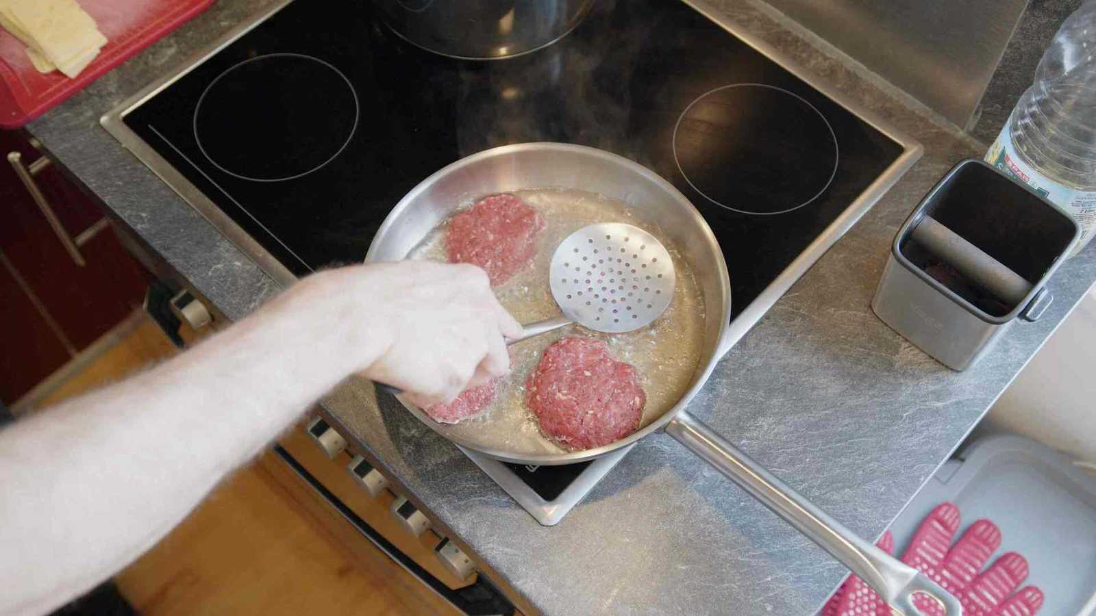 Spatula pressing on a patty