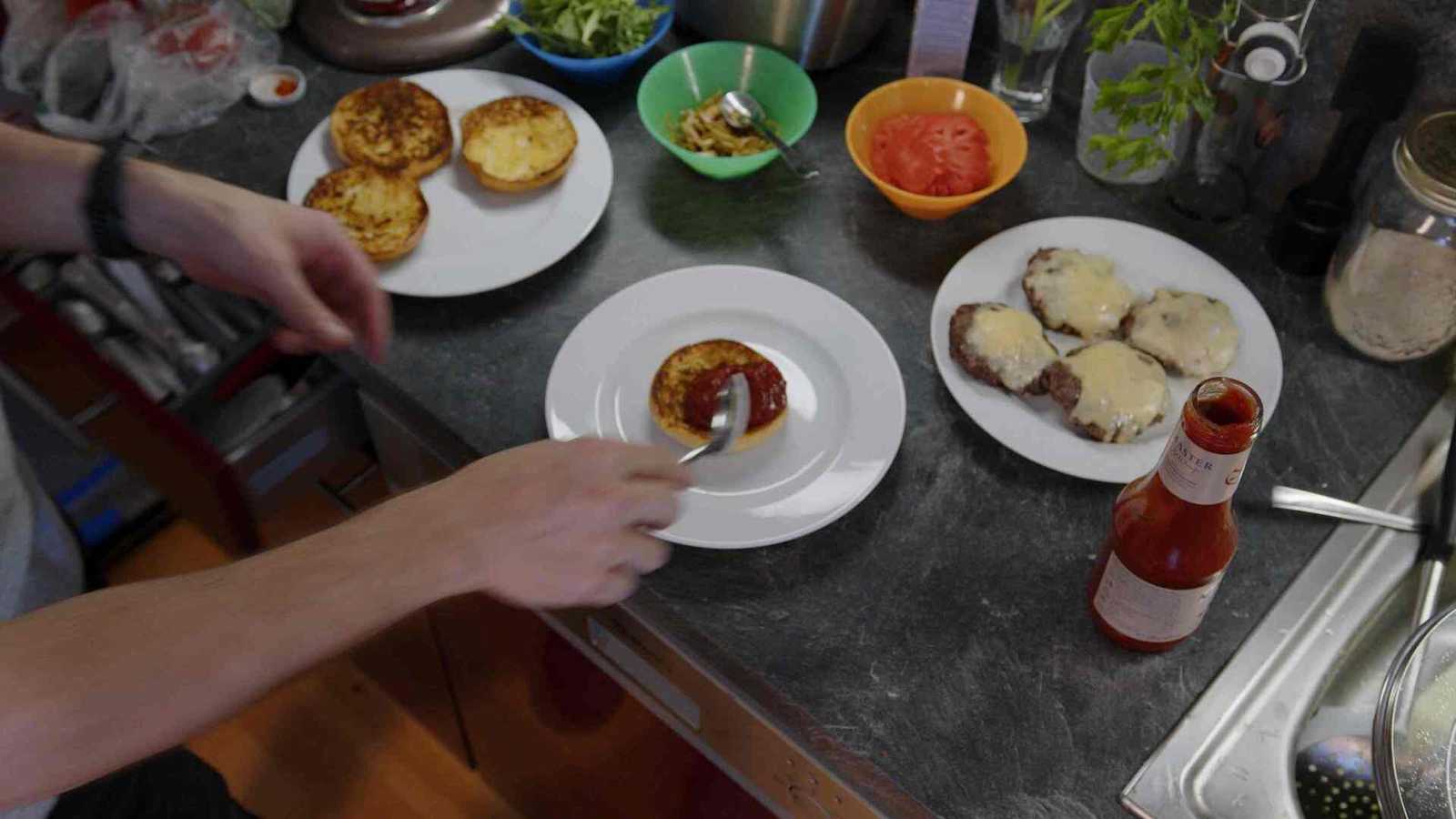 Ketchup being spread on the bun