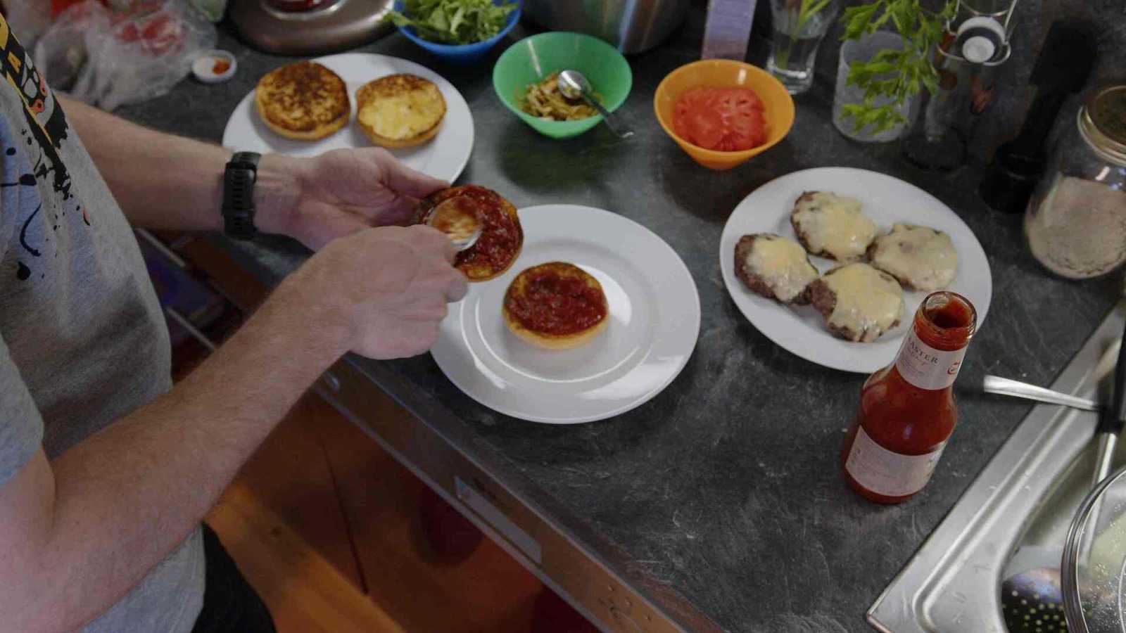 Ketchup being spread on the bun